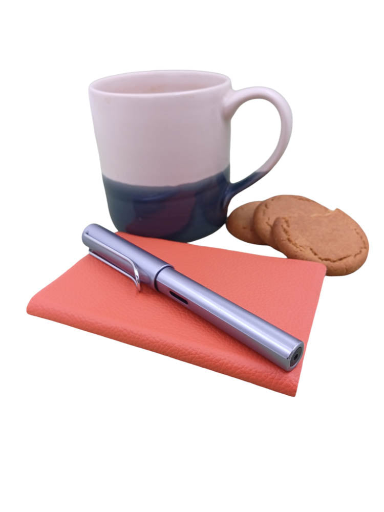 Pocket notebook sample orange with coffee mug - the index bindery